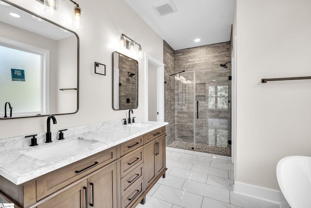 bathroom featuring vanity and a shower with shower door