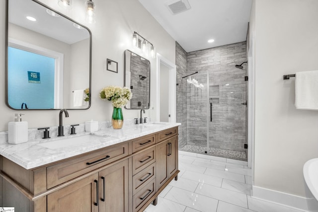 full bathroom with visible vents, marble finish floor, recessed lighting, a shower stall, and a sink