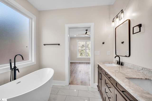 bathroom with vanity, wood-type flooring, a bathtub, and ceiling fan