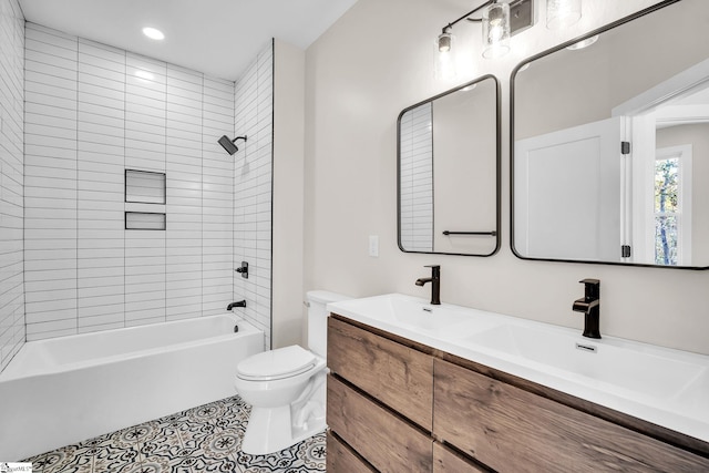 full bathroom with tiled shower / bath, vanity, and toilet