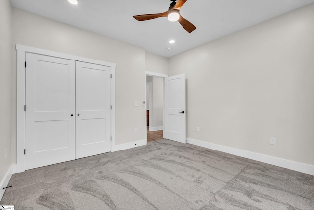unfurnished bedroom featuring baseboards, carpet, a closet, and recessed lighting