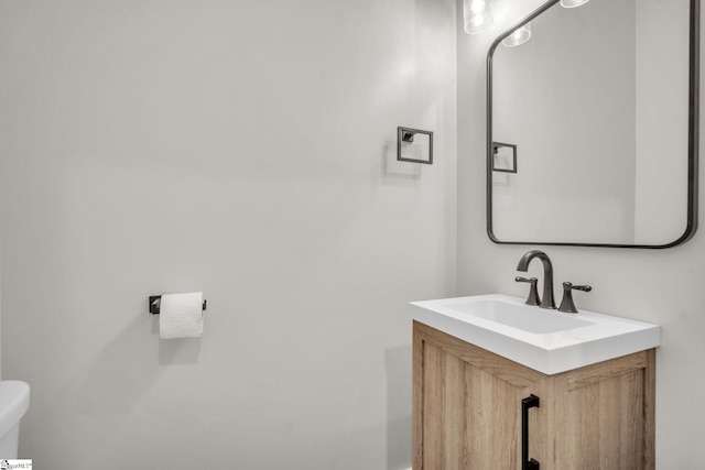 bathroom featuring toilet and vanity