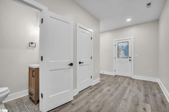 entrance foyer with visible vents, baseboards, and light wood-type flooring