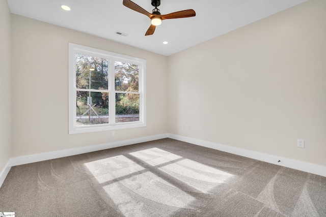 carpeted spare room featuring ceiling fan