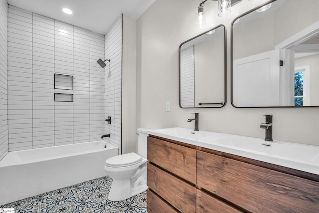 bathroom with double vanity, toilet, tile patterned floors, a sink, and shower / washtub combination