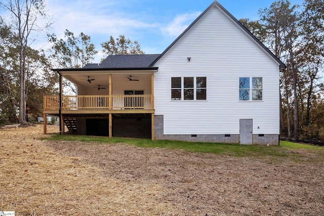 back of property with a wooden deck and ceiling fan