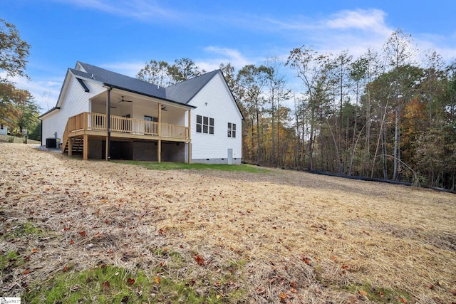 rear view of property featuring ceiling fan and central AC unit