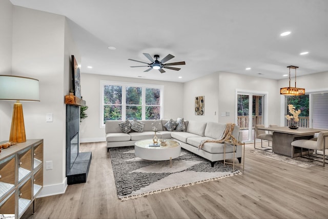 living area with recessed lighting, baseboards, ceiling fan, and wood finished floors