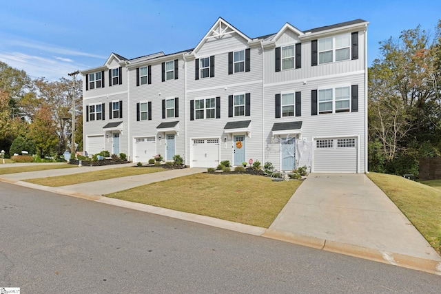 view of property featuring a front yard and a garage