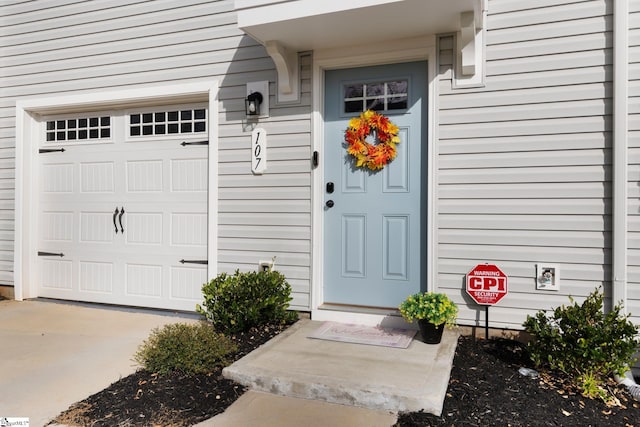 view of exterior entry featuring a garage