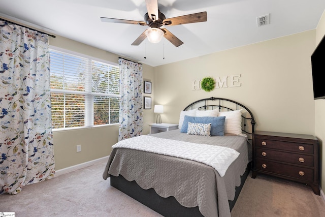 bedroom with ceiling fan and light colored carpet