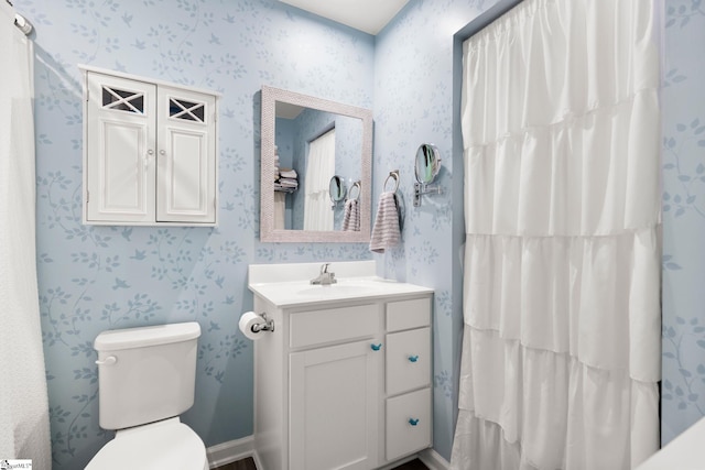 bathroom with vanity, toilet, and walk in shower