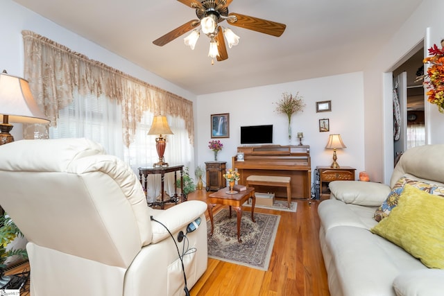 living room with ceiling fan and light wood-type flooring