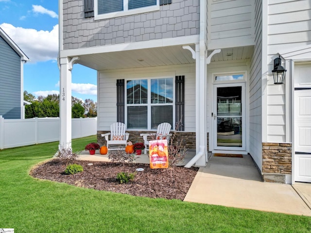 entrance to property featuring a lawn