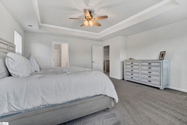 carpeted bedroom featuring a raised ceiling and ceiling fan