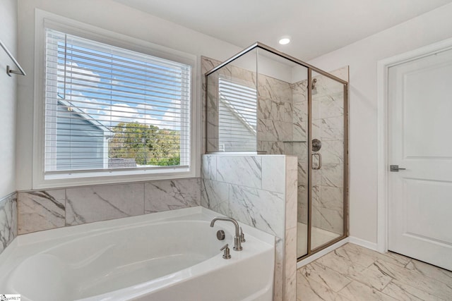 bathroom featuring separate shower and tub