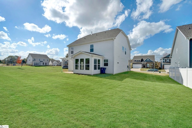 rear view of property with a yard