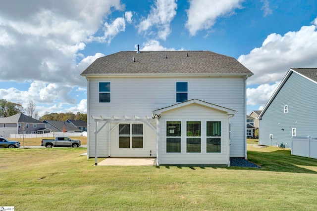 rear view of property featuring a patio and a lawn