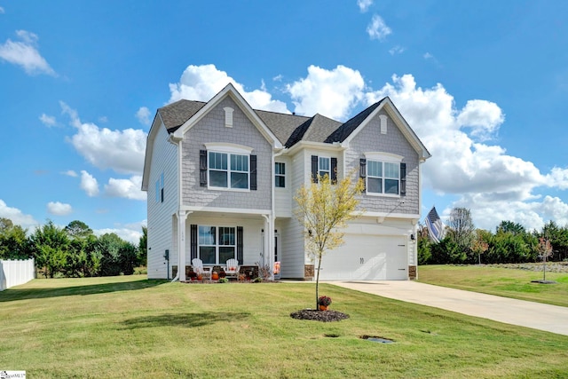 view of front of property featuring a front yard and a garage