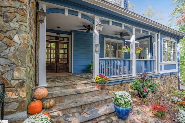 entrance to property with ceiling fan and a porch