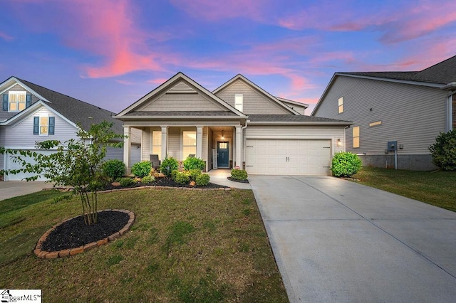 craftsman-style home featuring a yard and a garage