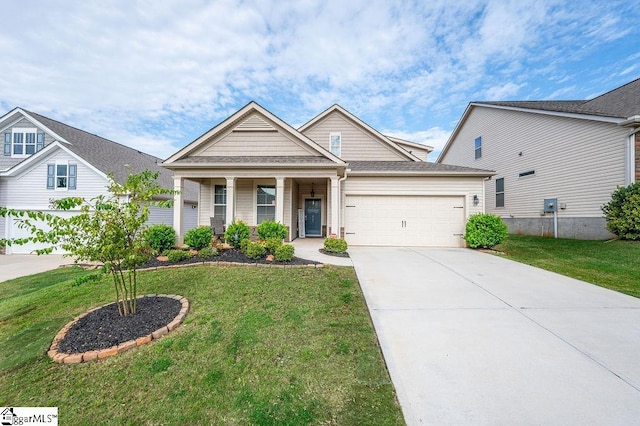 craftsman house with a front yard and a garage