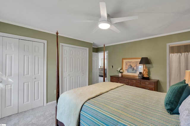 carpeted bedroom featuring ceiling fan, crown molding, and multiple closets