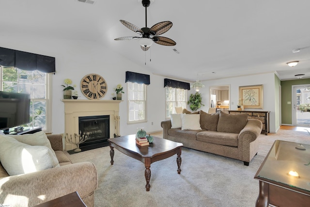 carpeted living room featuring ceiling fan and vaulted ceiling