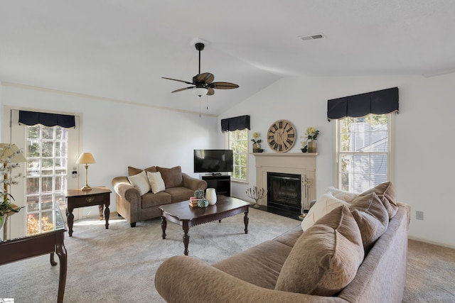 living room featuring vaulted ceiling, light carpet, and ceiling fan