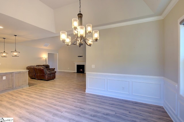 113 Bonaire Pointe Smithbrook Subdivision, Anderson, SC 29621 - unfurnished living room featuring wainscoting, wood finished floors, lofted ceiling, a chandelier, and a decorative wall