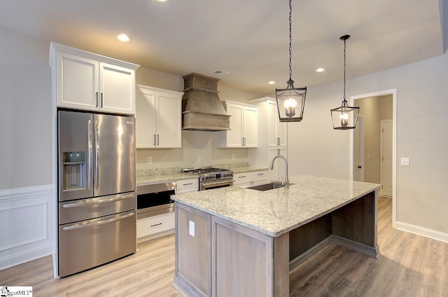 113 Bonaire Pointe Smithbrook Subdivision, Anderson, SC 29621 - kitchen featuring appliances with stainless steel finishes, a sink, premium range hood, white cabinets, and a center island with sink