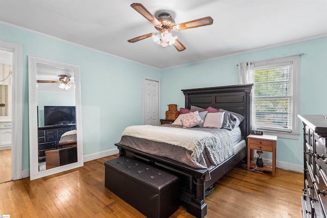 bedroom with ornamental molding, wood-type flooring, and ceiling fan