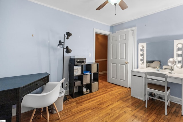 office featuring crown molding, light wood-type flooring, and ceiling fan