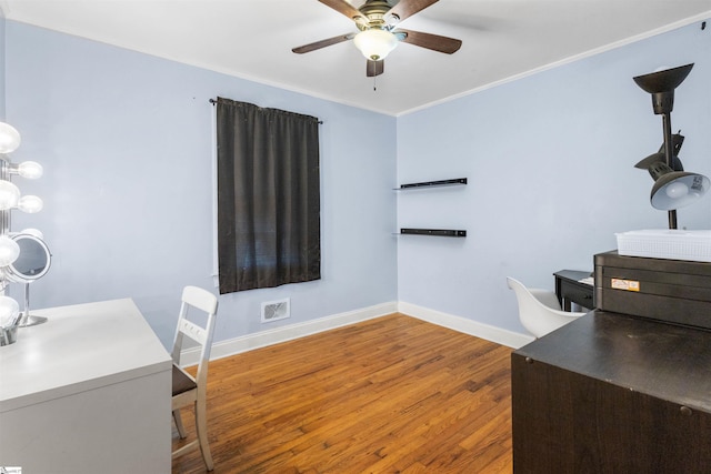 office area with crown molding, wood-type flooring, and ceiling fan