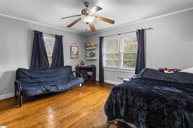 bedroom featuring ornamental molding, hardwood / wood-style flooring, and ceiling fan