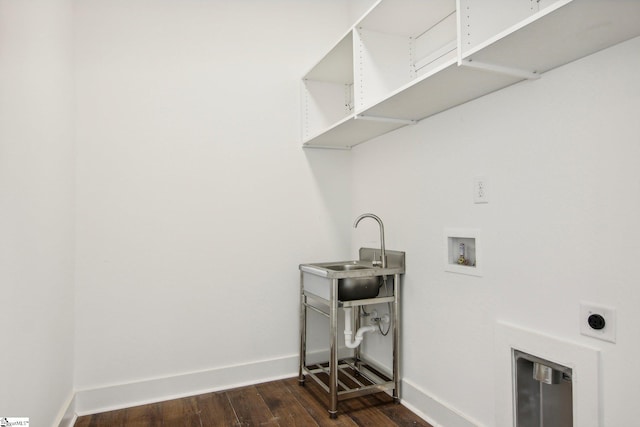 clothes washing area featuring hookup for an electric dryer, dark wood-type flooring, hookup for a washing machine, and sink