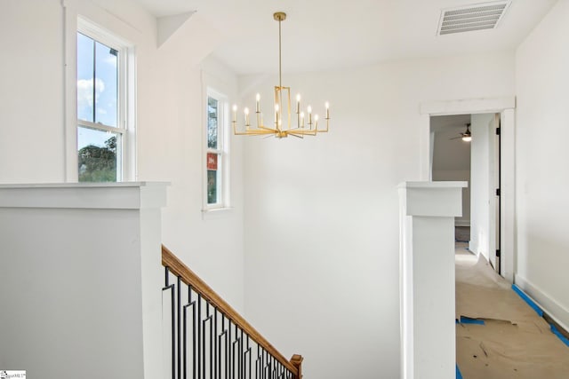 corridor featuring a notable chandelier