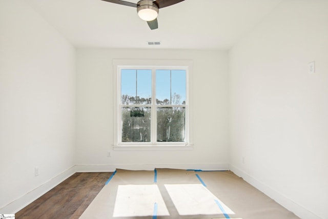 spare room with ceiling fan and dark hardwood / wood-style flooring