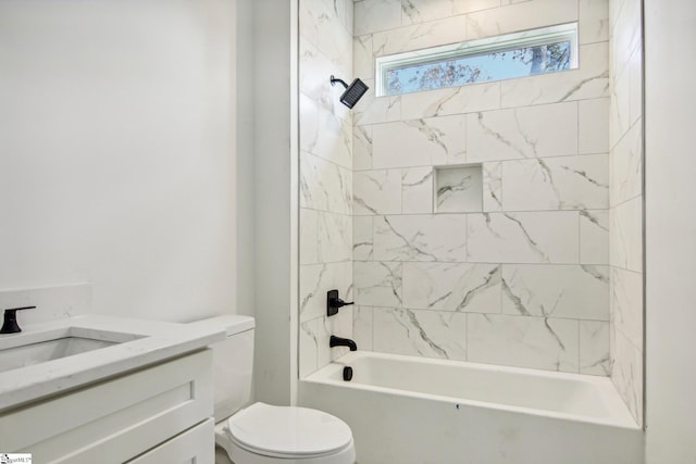 full bathroom featuring tiled shower / bath, vanity, and toilet