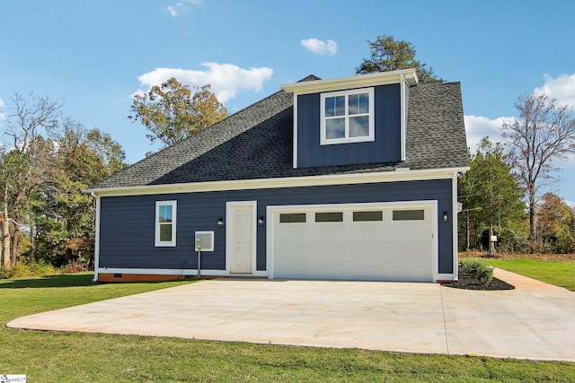 view of front of property with a front yard and a garage