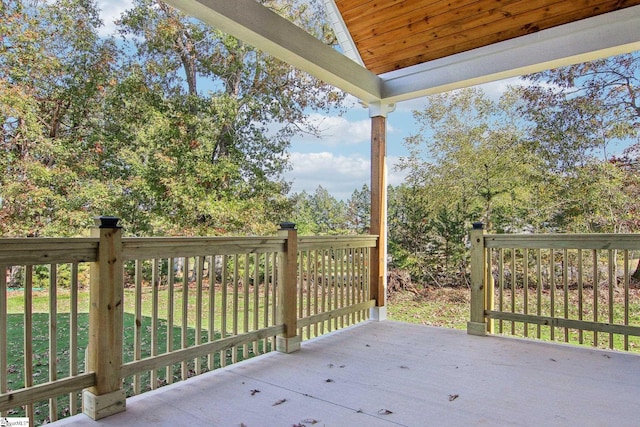 wooden deck featuring a lawn