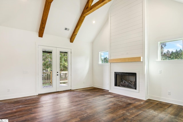 unfurnished living room featuring french doors, a large fireplace, beam ceiling, high vaulted ceiling, and dark hardwood / wood-style floors