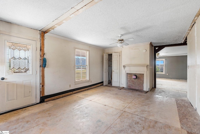 unfurnished living room featuring a textured ceiling and ceiling fan