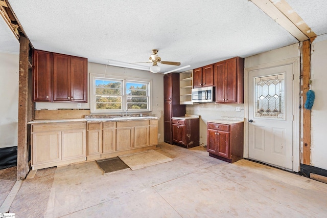 kitchen with a textured ceiling and ceiling fan