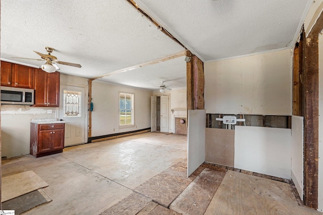 kitchen with a textured ceiling and ceiling fan