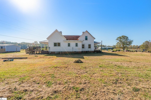 back of property with a lawn