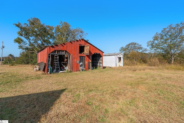 view of outdoor structure featuring a lawn