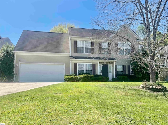 view of front of property with a front yard and a garage