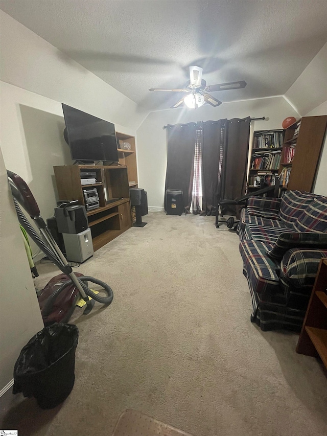 carpeted living room featuring lofted ceiling, a textured ceiling, and ceiling fan