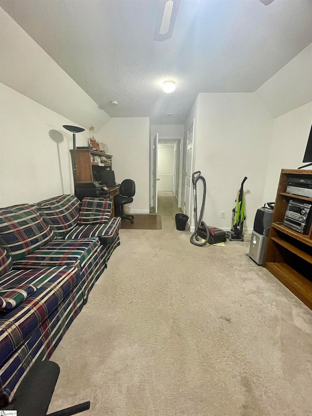 living room with lofted ceiling, a textured ceiling, and carpet flooring